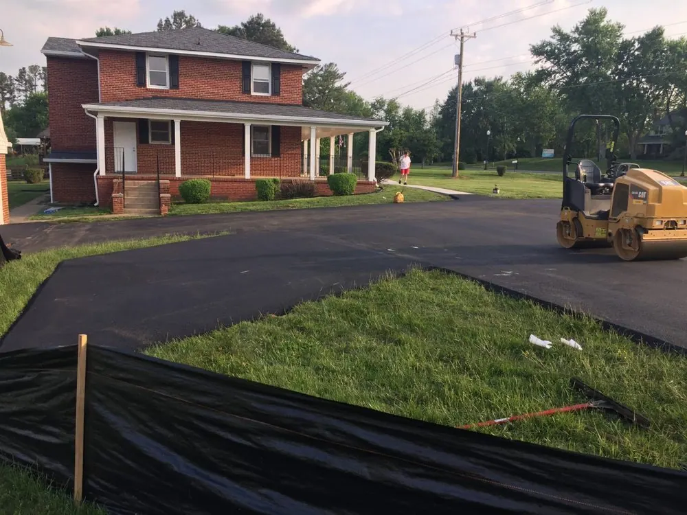 Before condition of mixed-use access lane with visible wear and patching